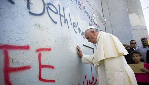 Pope Francis prays at the Israeli-built separation barrier in Bethlehem in the West Bank